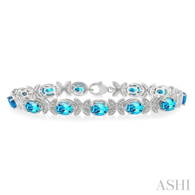 Ladies bracelets pearl details-1/10 Ctw Round Cut Diamond & 7x5MM Oval Cut Blue Topaz Semi Precious Bracelet in Sterling Silver