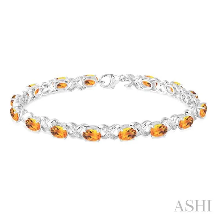 Ladies bracelets name engravings-7x5 mm Oval Cut Citrine and 1/20 Ctw Round Cut Diamond Fashion Bracelet in Sterling Silver