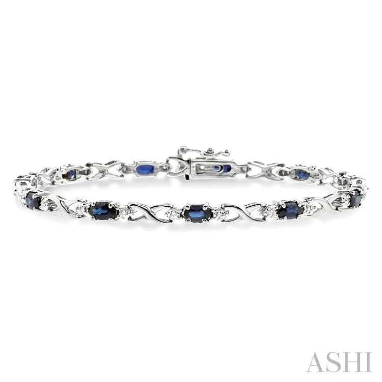 Ladies bracelets rose gold-5x3mm Oval Cut Sapphire and 1/10 Ctw Single Cut Diamond Bracelet in 10K White Gold