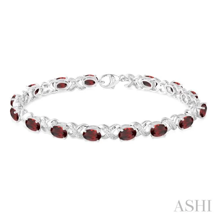 Ladies bracelets heartfelt keepsakes-7x5 mm Oval Cut Garnet and 1/20 Ctw Round Cut Diamond Fashion Bracelet in Sterling Silver