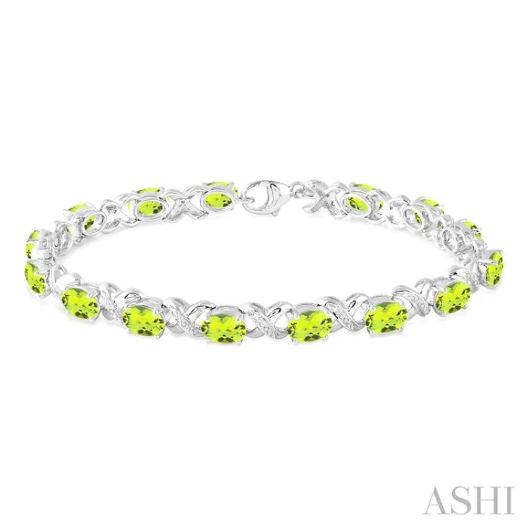 Ladies bracelets feather-light-7x5 mm Oval Cut Peridot and 1/20 Ctw Round Cut Diamond Fashion Bracelet in Sterling Silver